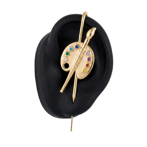Artist ear cuff in gold on a black ear form