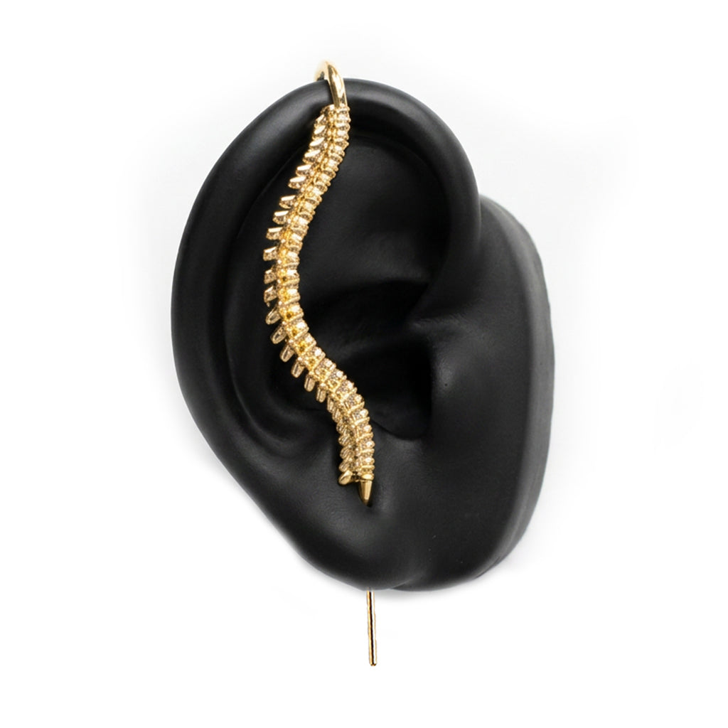 Spine-Chilling ear cuff in gold on a black ear form