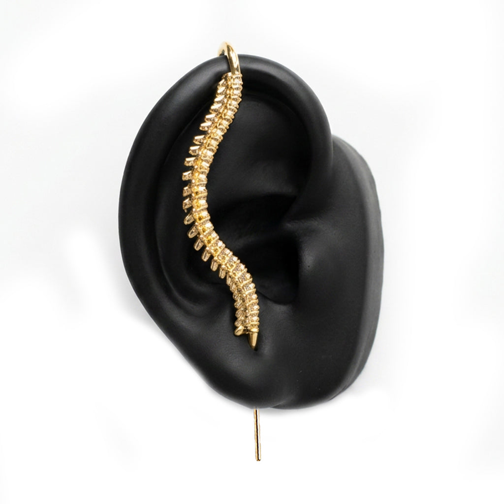 Spine-Chilling ear cuff in gold on a black ear form