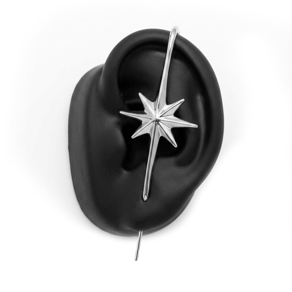 North Star ear cuff in silver on a black ear form
