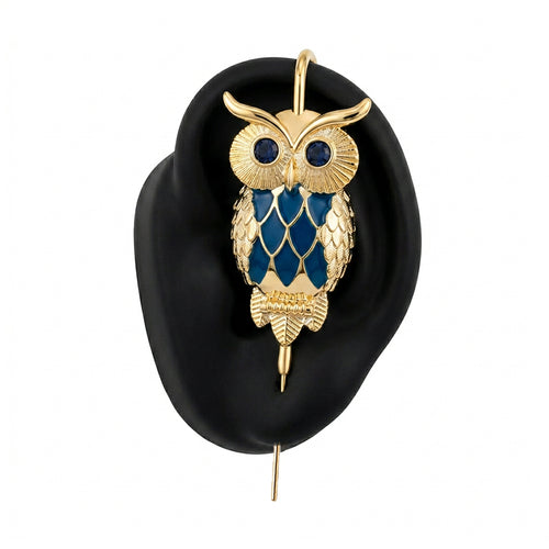 Night Owl ear cuff in gold on a black ear form