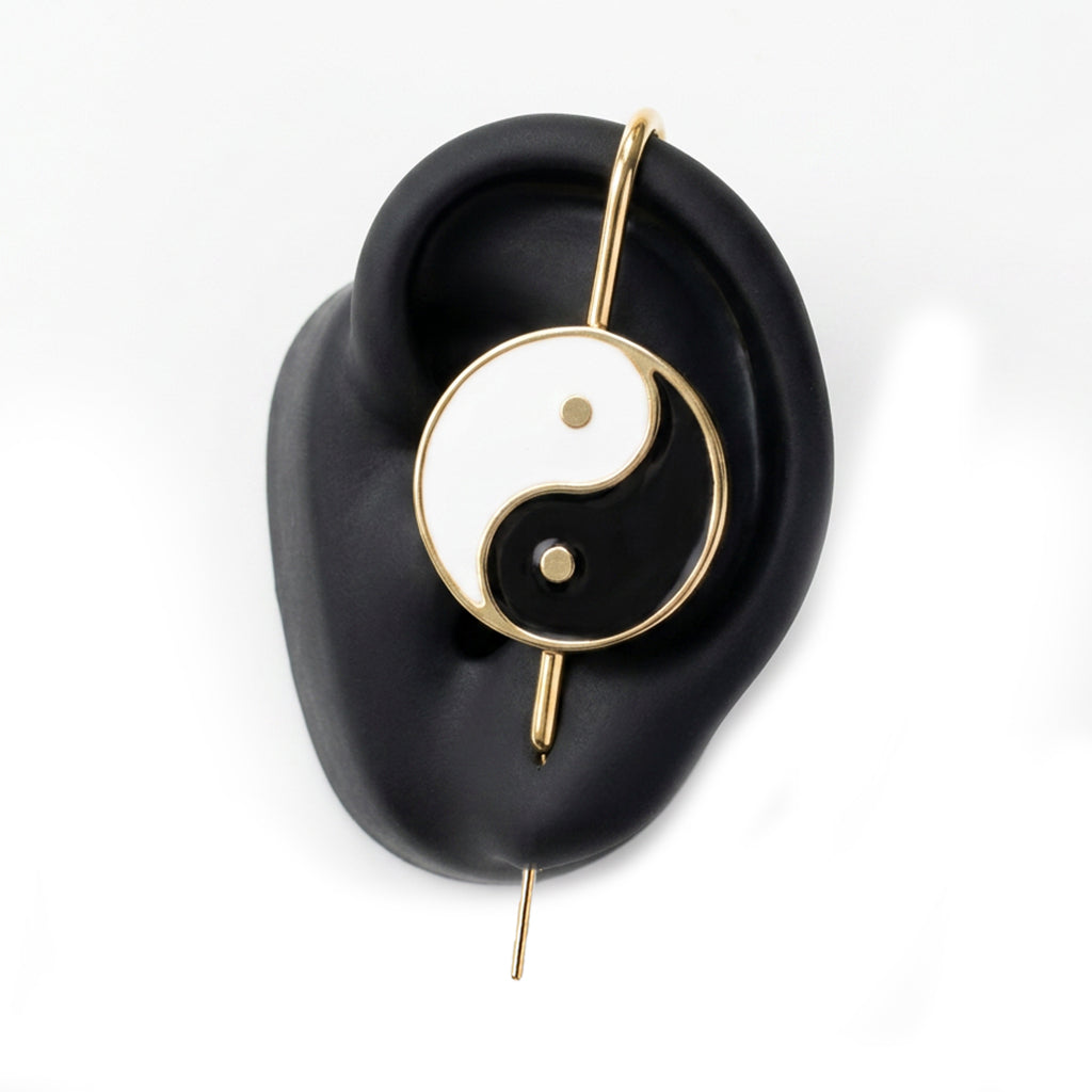 Yin & Yang ear cuff in gold on a black ear form