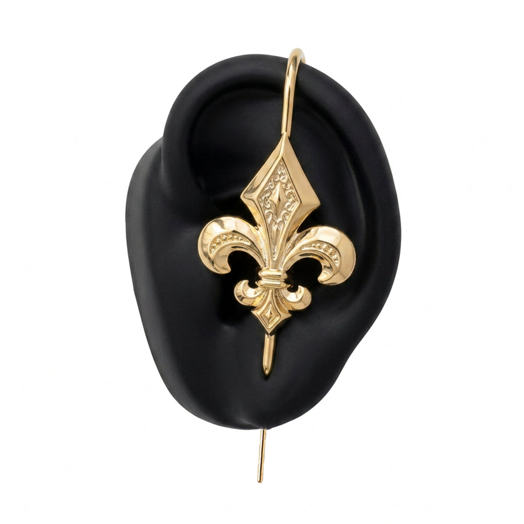 Fleur De Lys ear cuff in gold on a black ear form