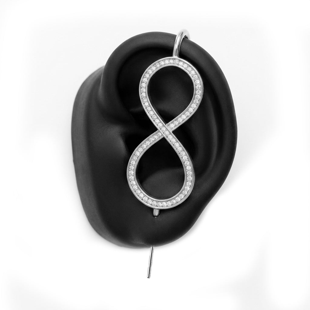 Infinity ear cuff in silver on a black ear form