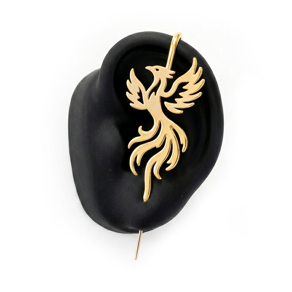Rising Phoenix ear cuff in gold on a black ear form