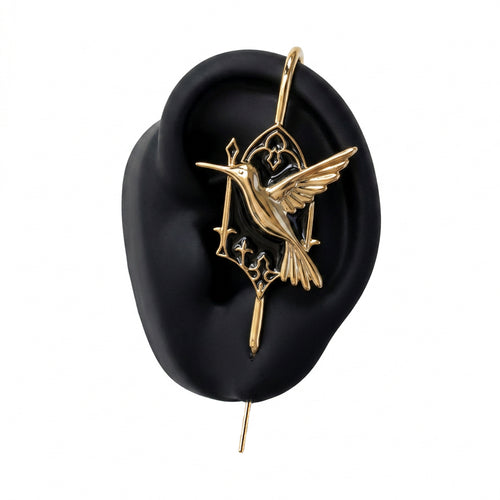 Hummingbird ear cuff in gold on a black ear form