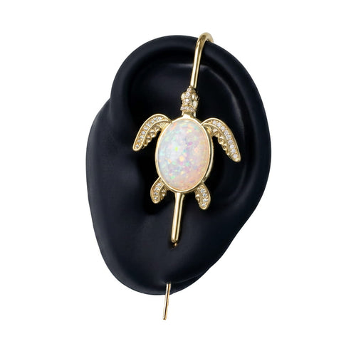 Ocean Guardian ear cuff in gold on a black ear form