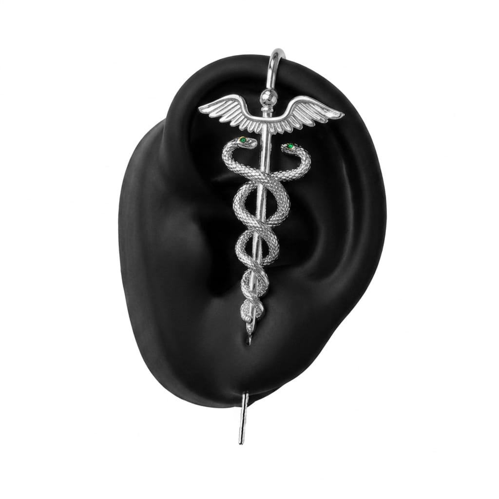 Caduceus ear cuff in silver on a black ear form