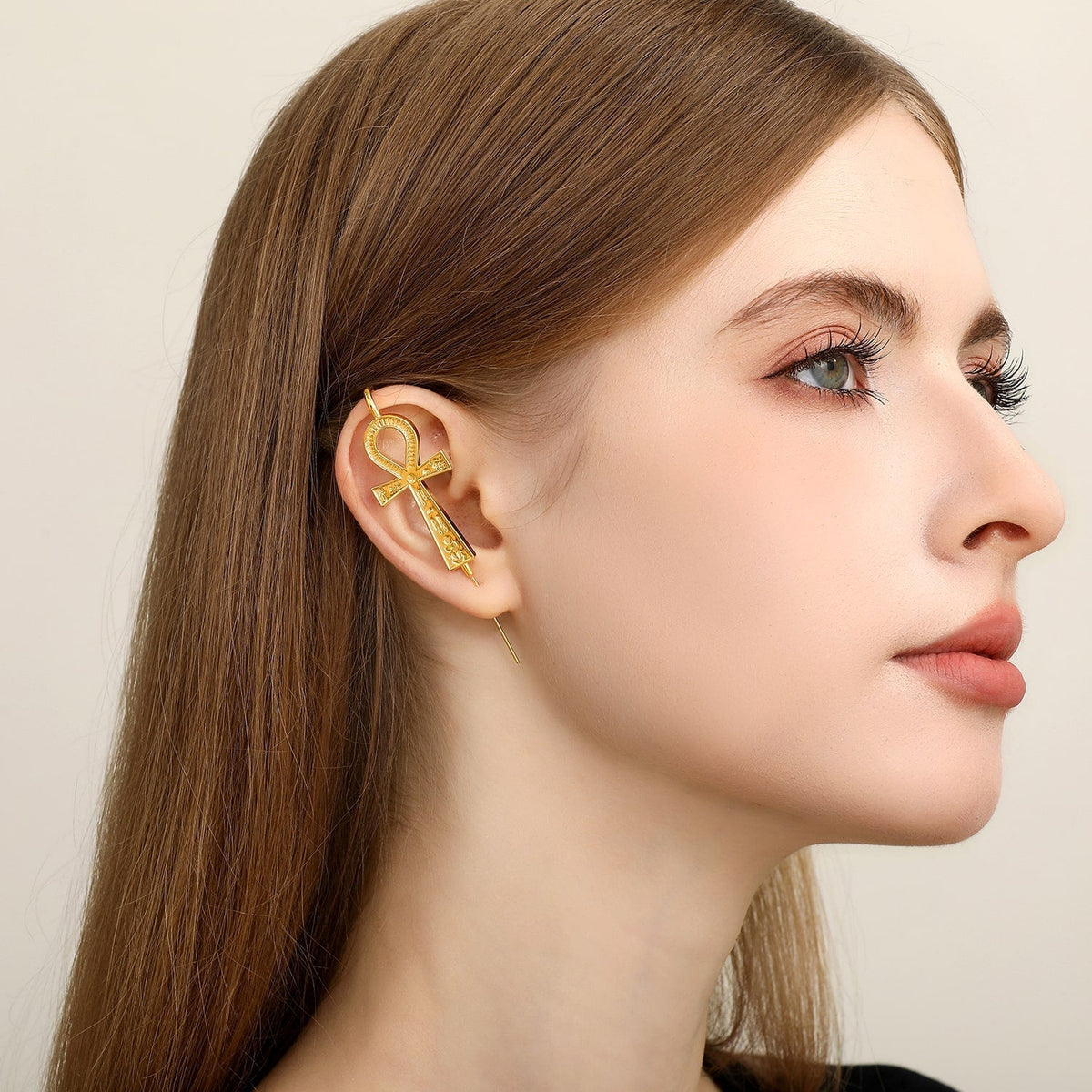 Ankh ear cuff worn on the ear, profile view