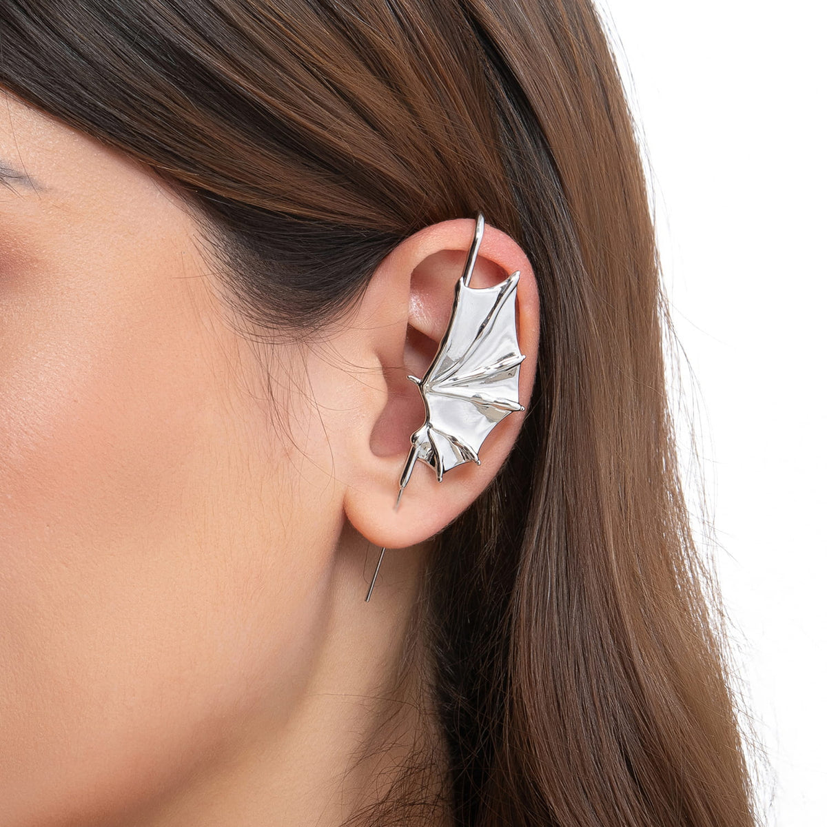 Nightfall Wings ear cuff in silver on a black ear form