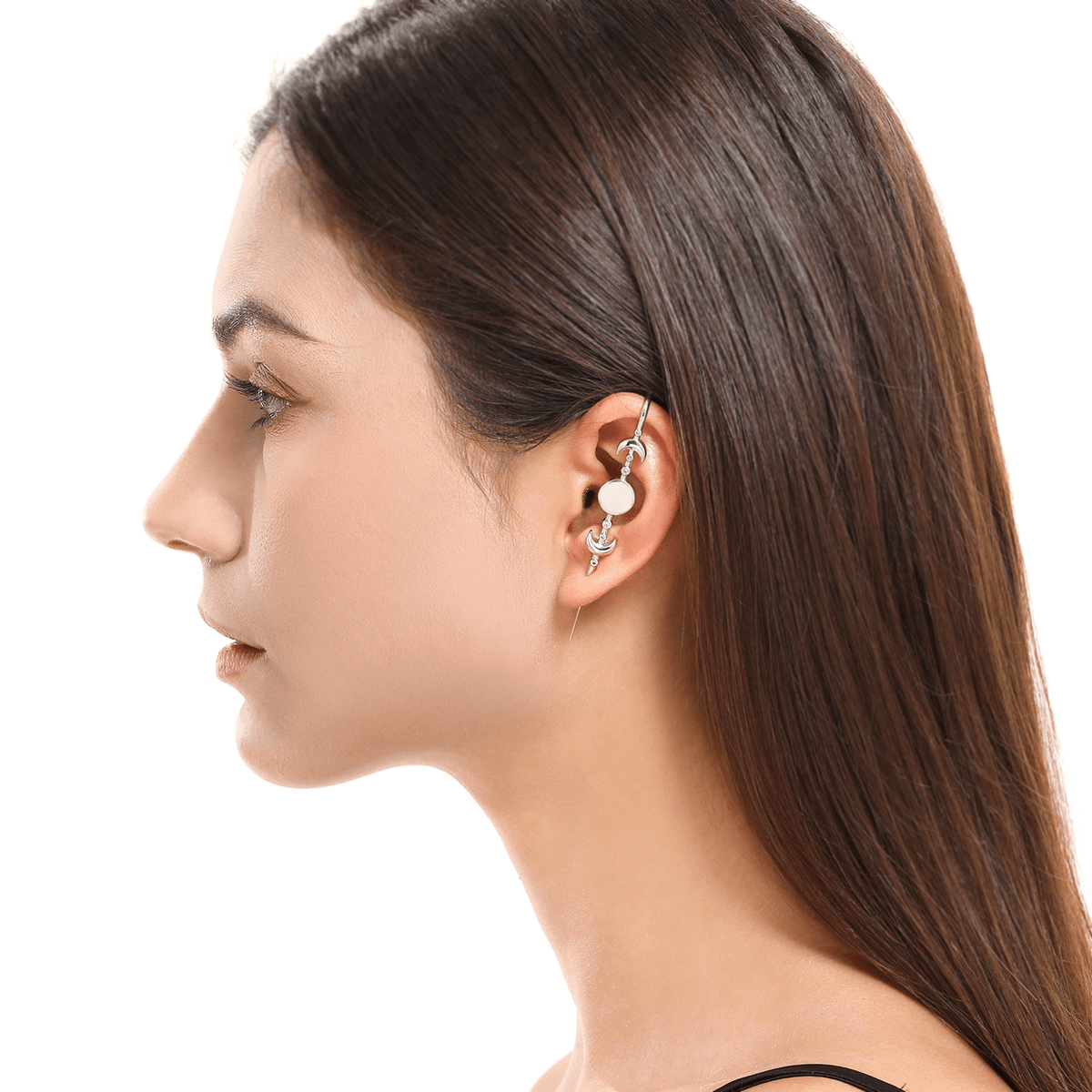 Moon Phases ear cuff in silver worn on the ear, profile view