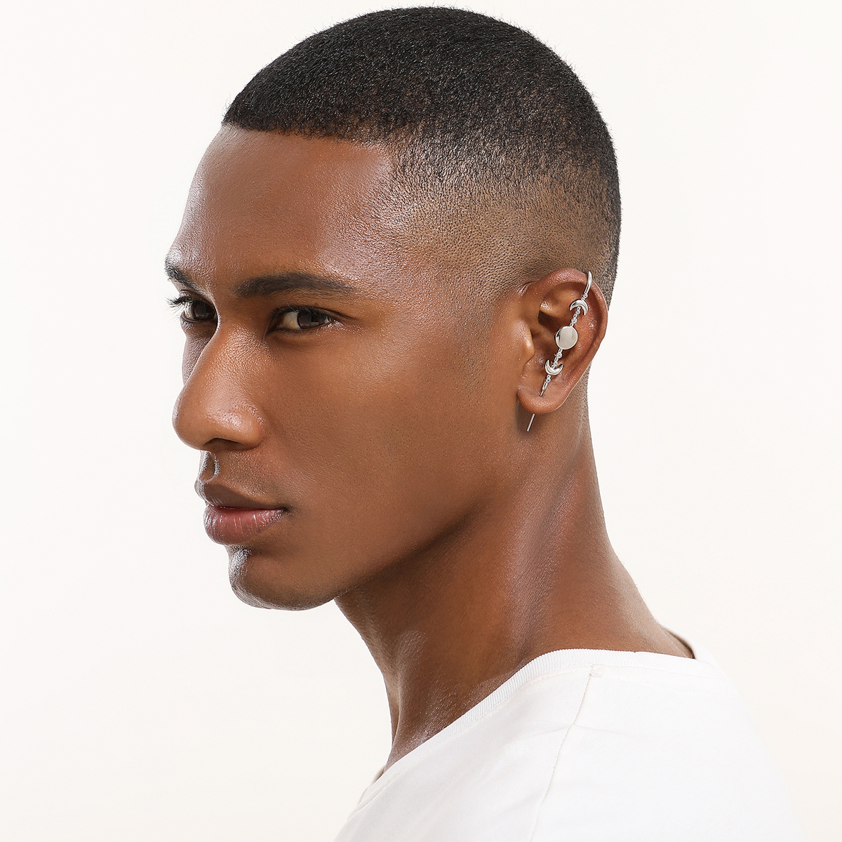 Moon Phases ear cuff in silver worn on the ear, profile view