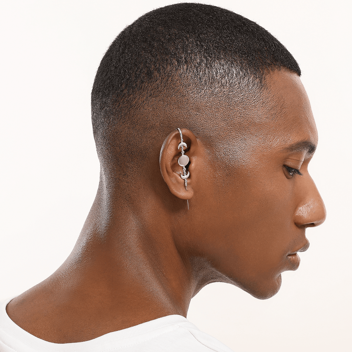Moon Phases ear cuff in silver worn on the ear, profile view