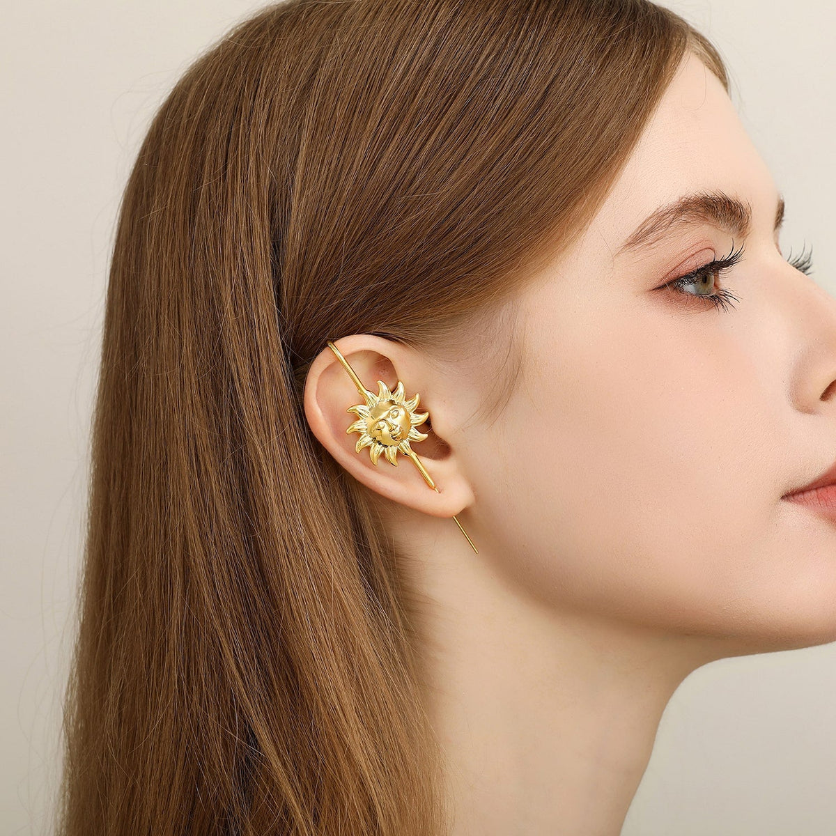 Sun & Moon ear cuff in gold worn on the ear, profile view
