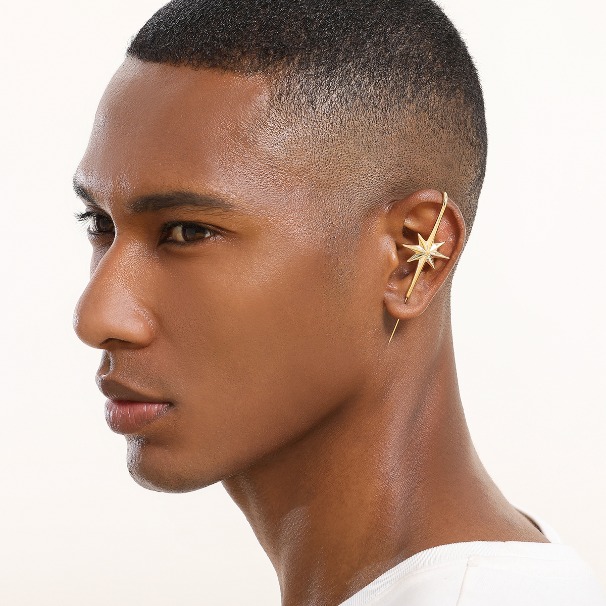 North Star ear cuff in gold worn on the ear, profile view