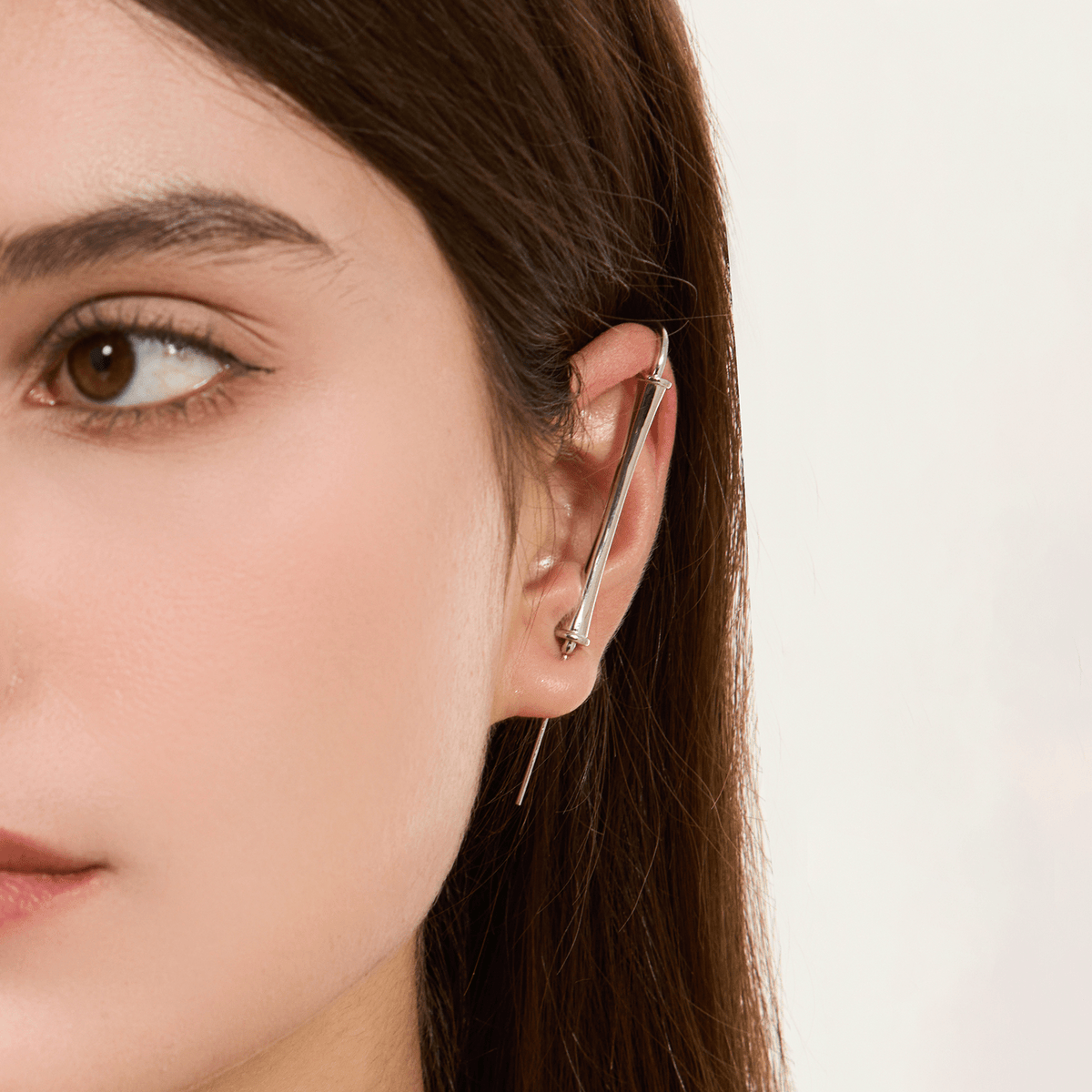 Pillar of Fortitude ear cuff in silver worn on the ear, profile view