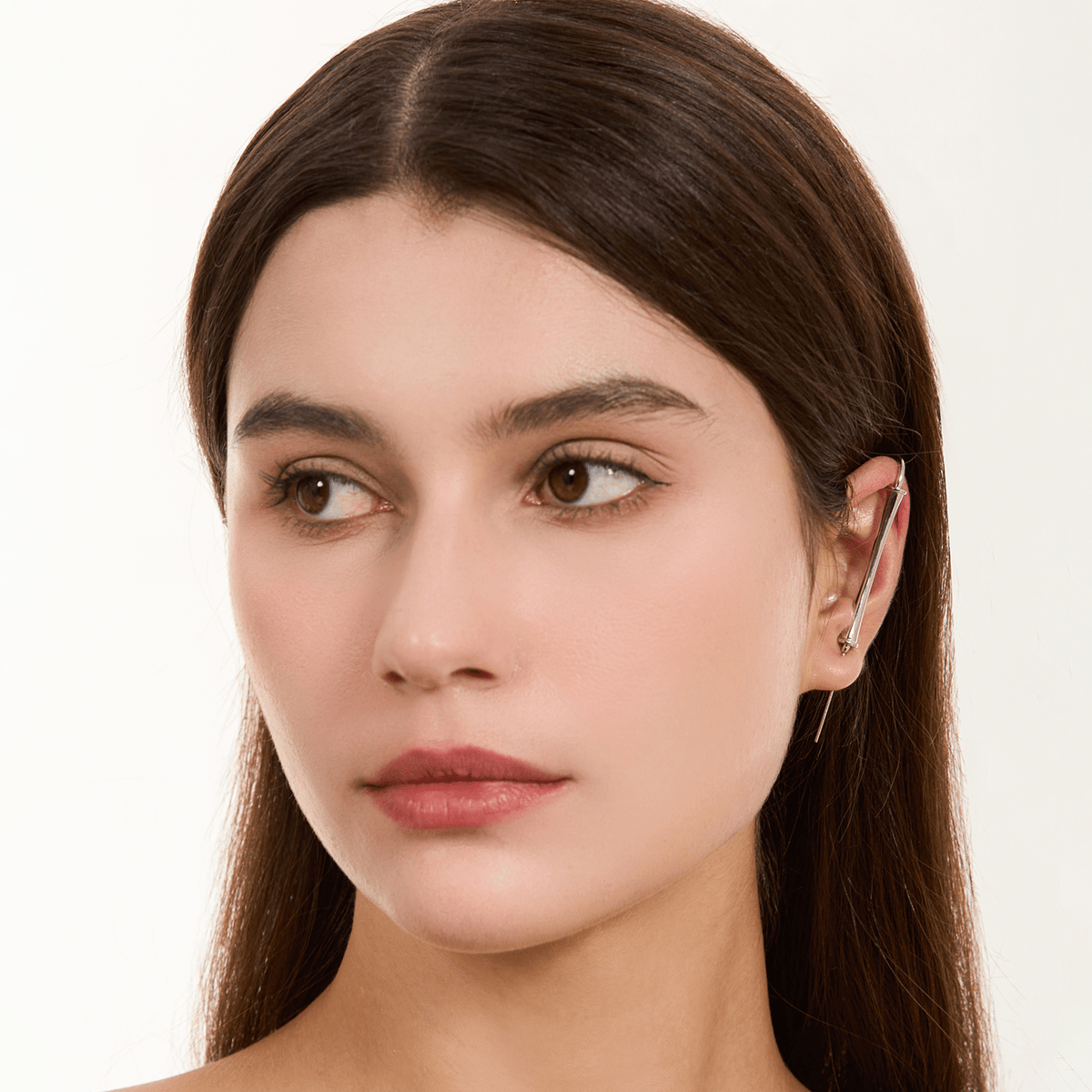 Pillar of Fortitude ear cuff in silver worn on the ear, profile view
