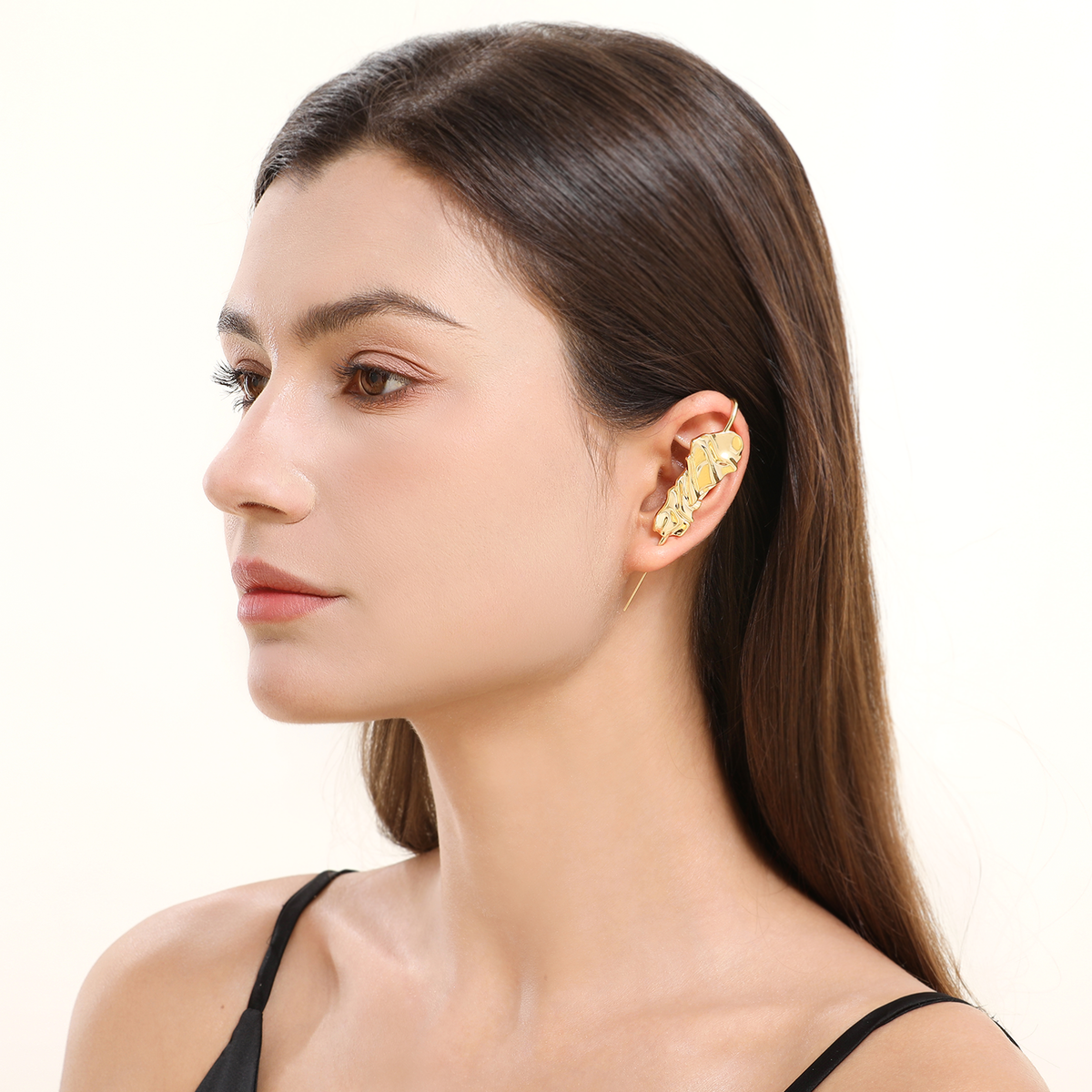 Sculpted Cascade ear cuff in gold worn on the ear, profile view