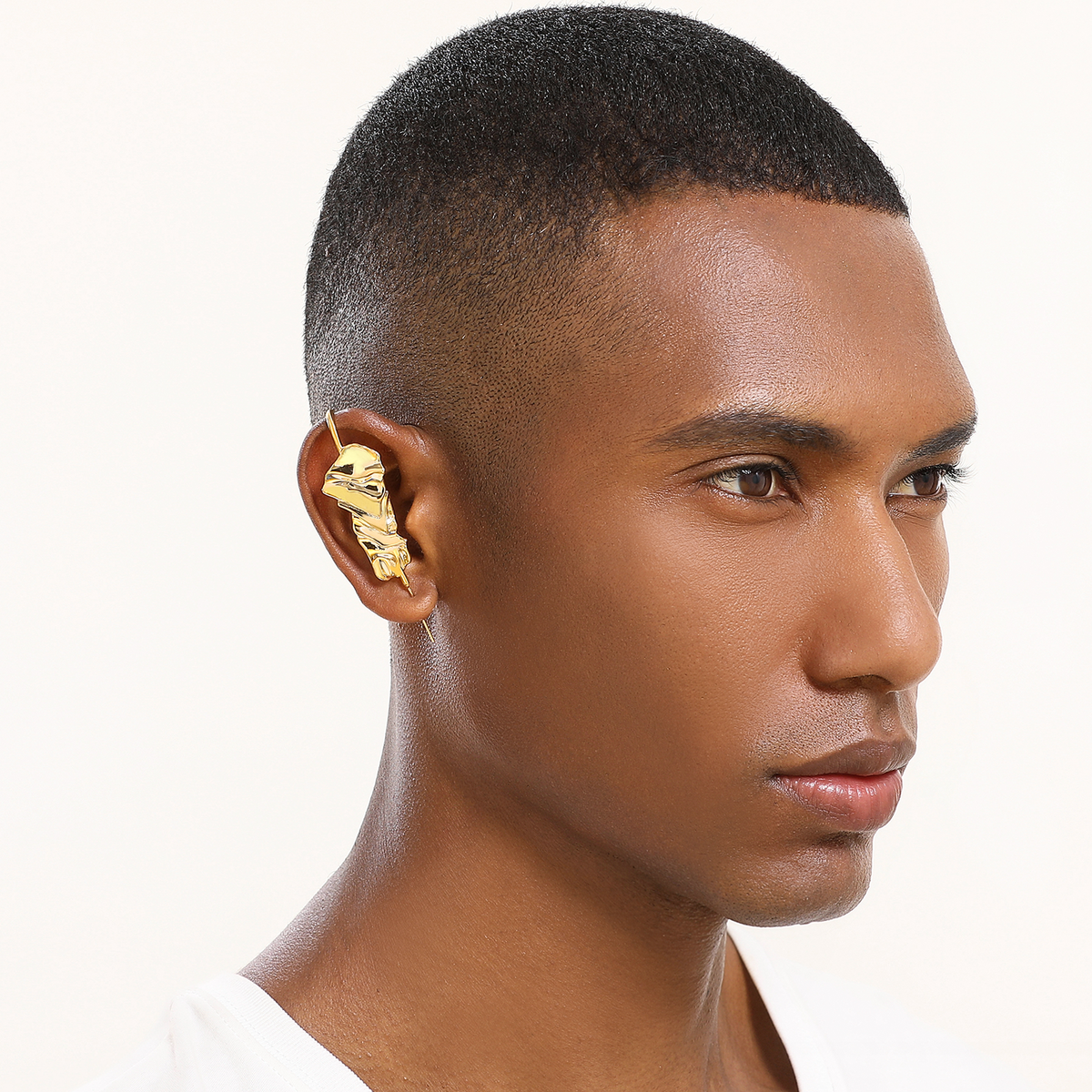 Sculpted Cascade ear cuff in gold worn on the ear, profile view
