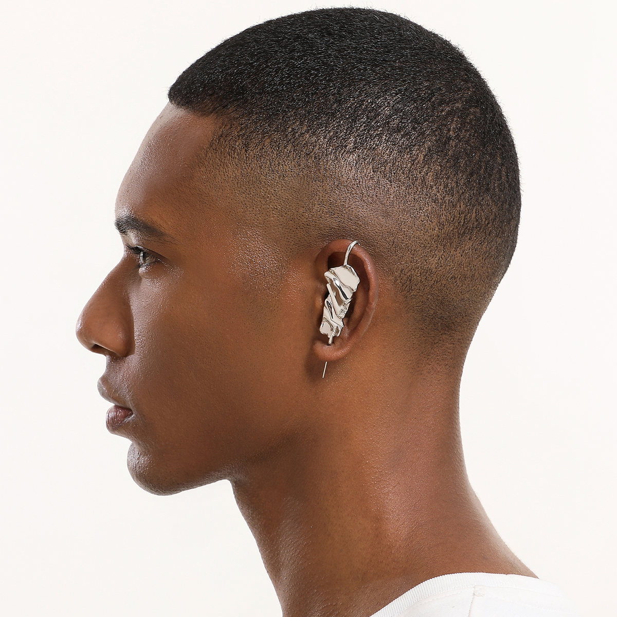 Sculpted Cascade ear cuff in silver worn on the ear, profile view