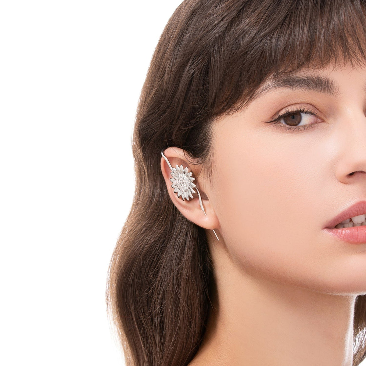 Sunflower ear cuff worn on the ear, profile view
