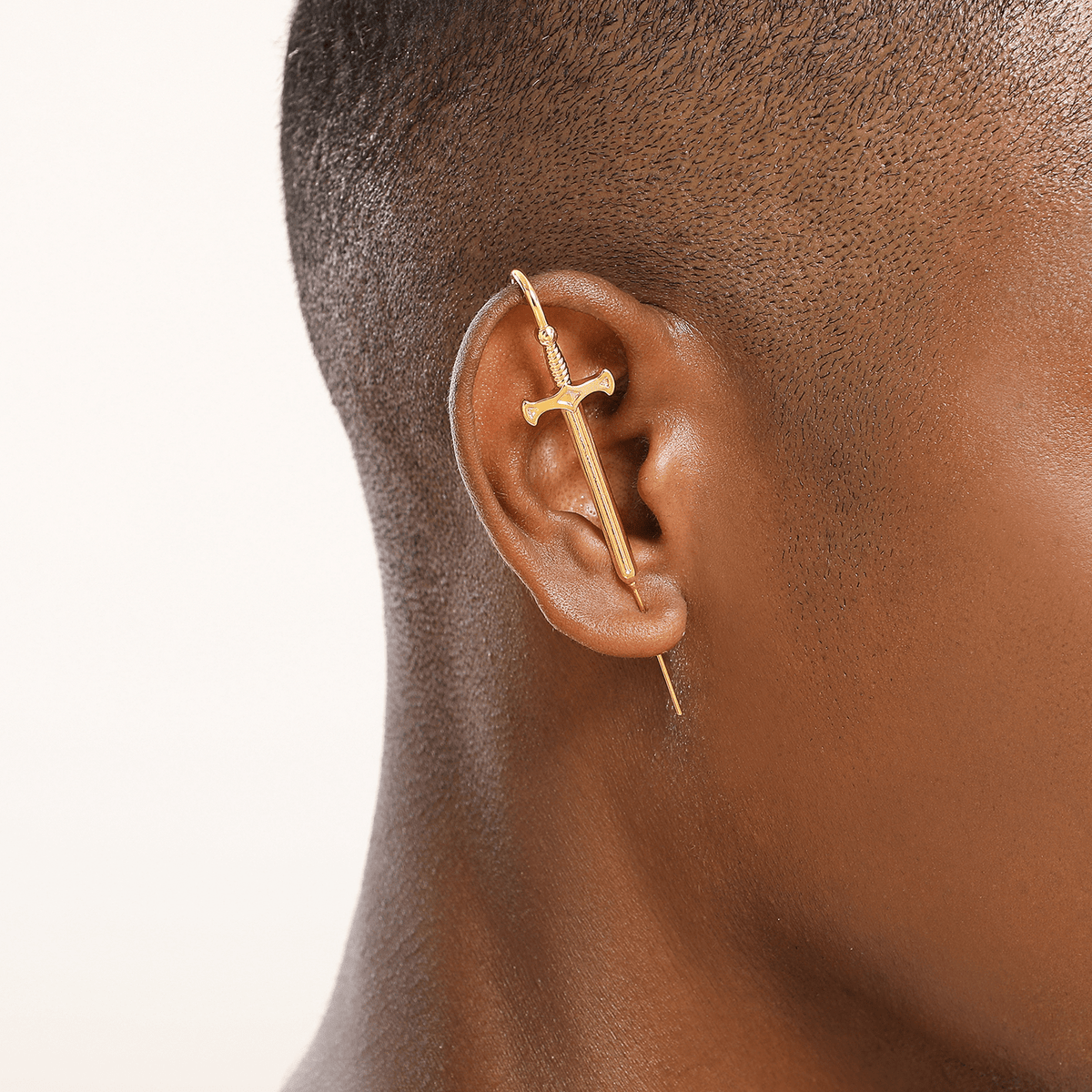 Titan's Edge ear cuff in gold worn on the ear, profile view