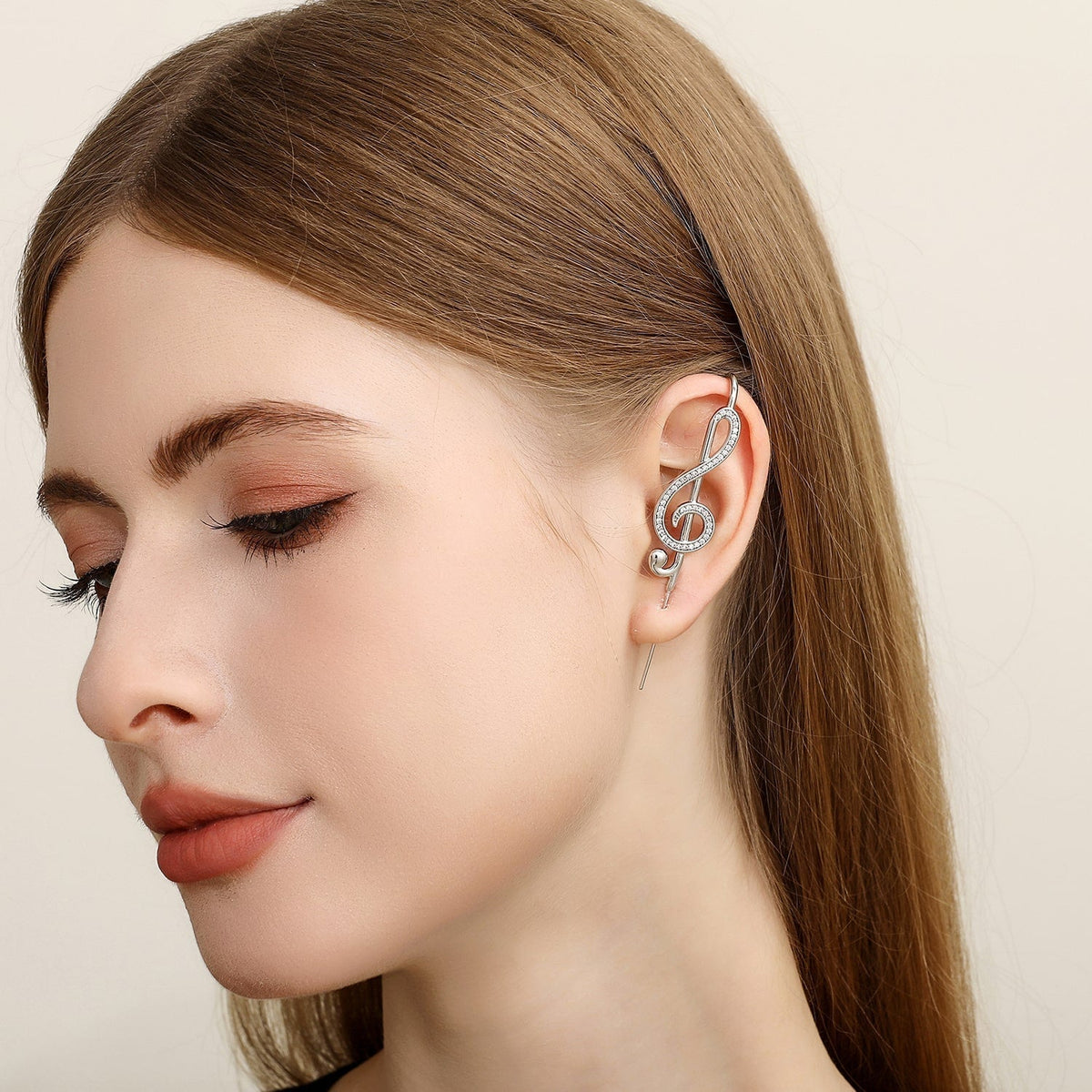 Treble Clef ear cuff worn on the ear, profile view