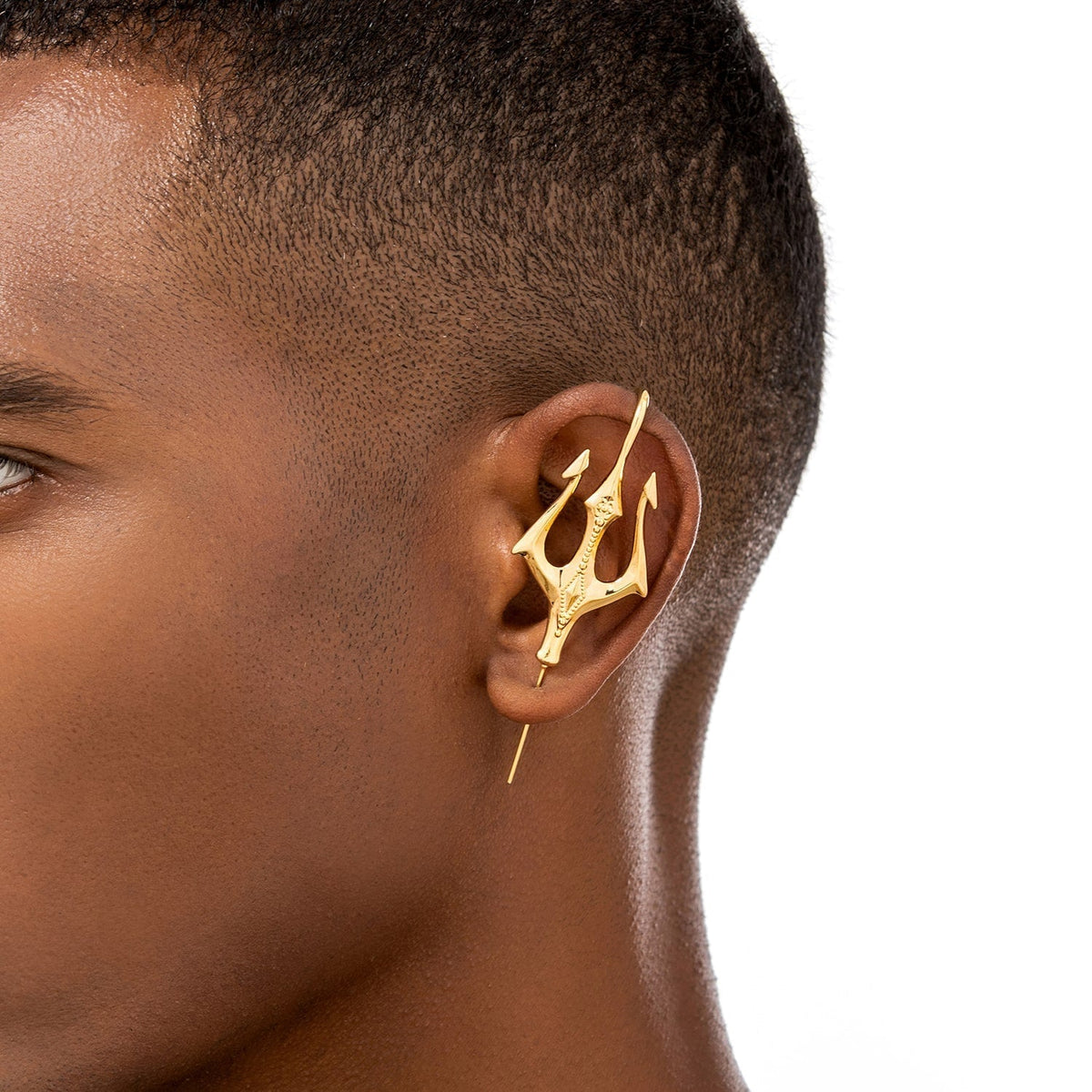 Poseidon's Trident ear cuff worn on the ear, profile view