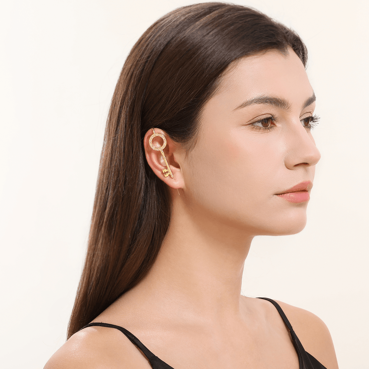 Unlocked Potential ear cuff in gold worn on the ear, profile view