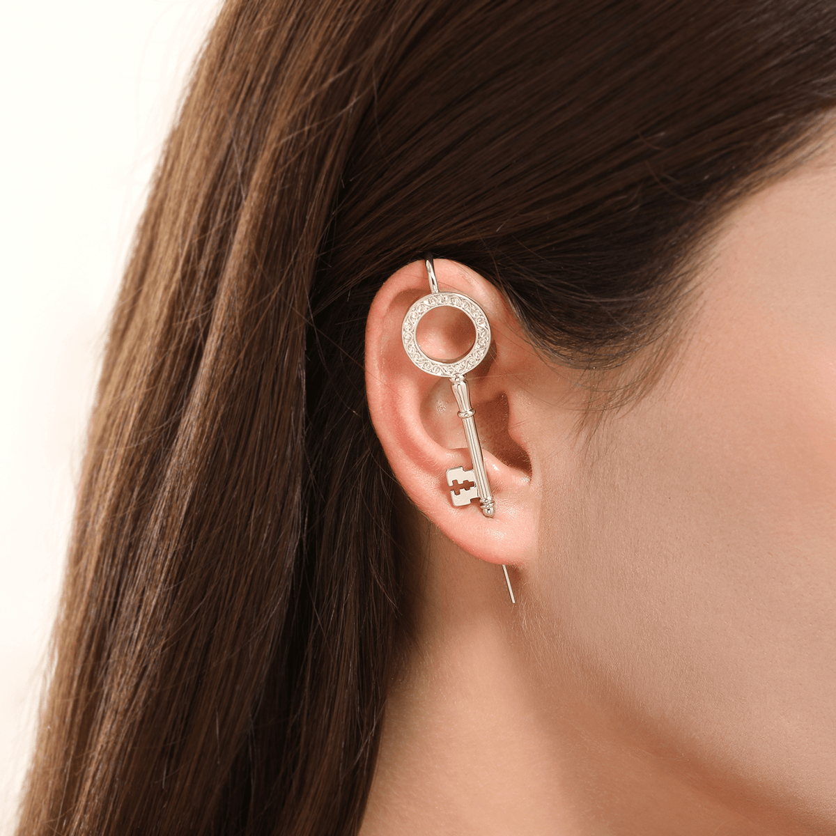 Unlocked Potential ear cuff in silver worn on the ear, profile view