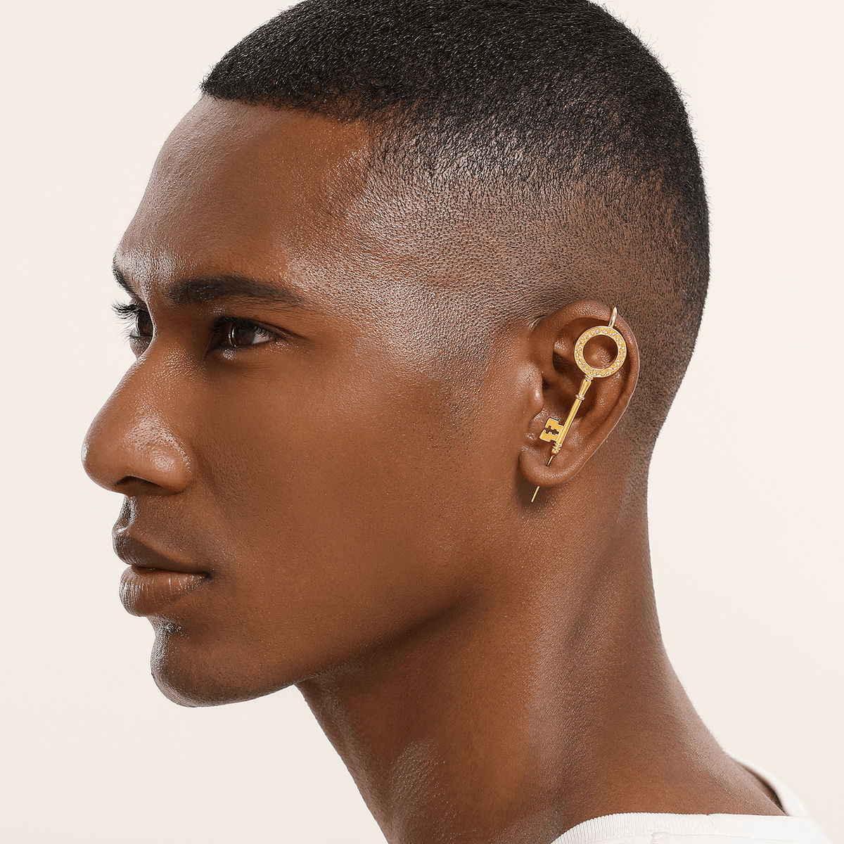 Unlocked Potential ear cuff in gold worn on the ear, profile view