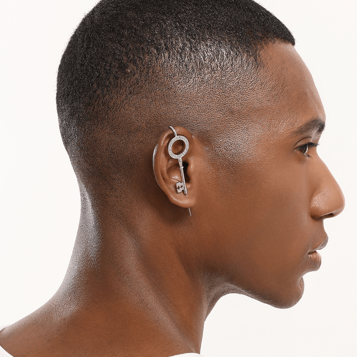 Unlocked Potential ear cuff in silver worn on the ear, profile view