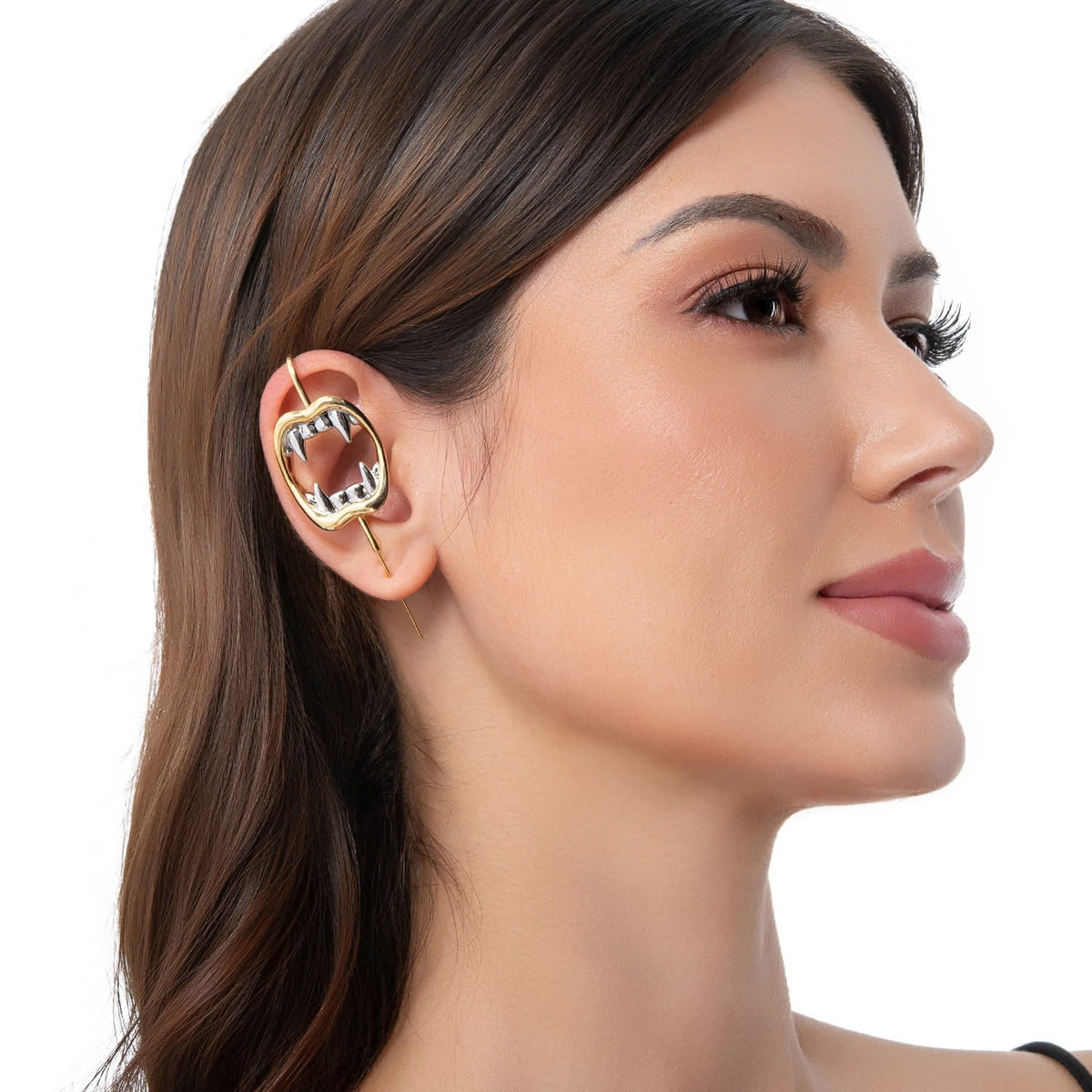 Vampire Fangs ear cuff in gold on a black ear form