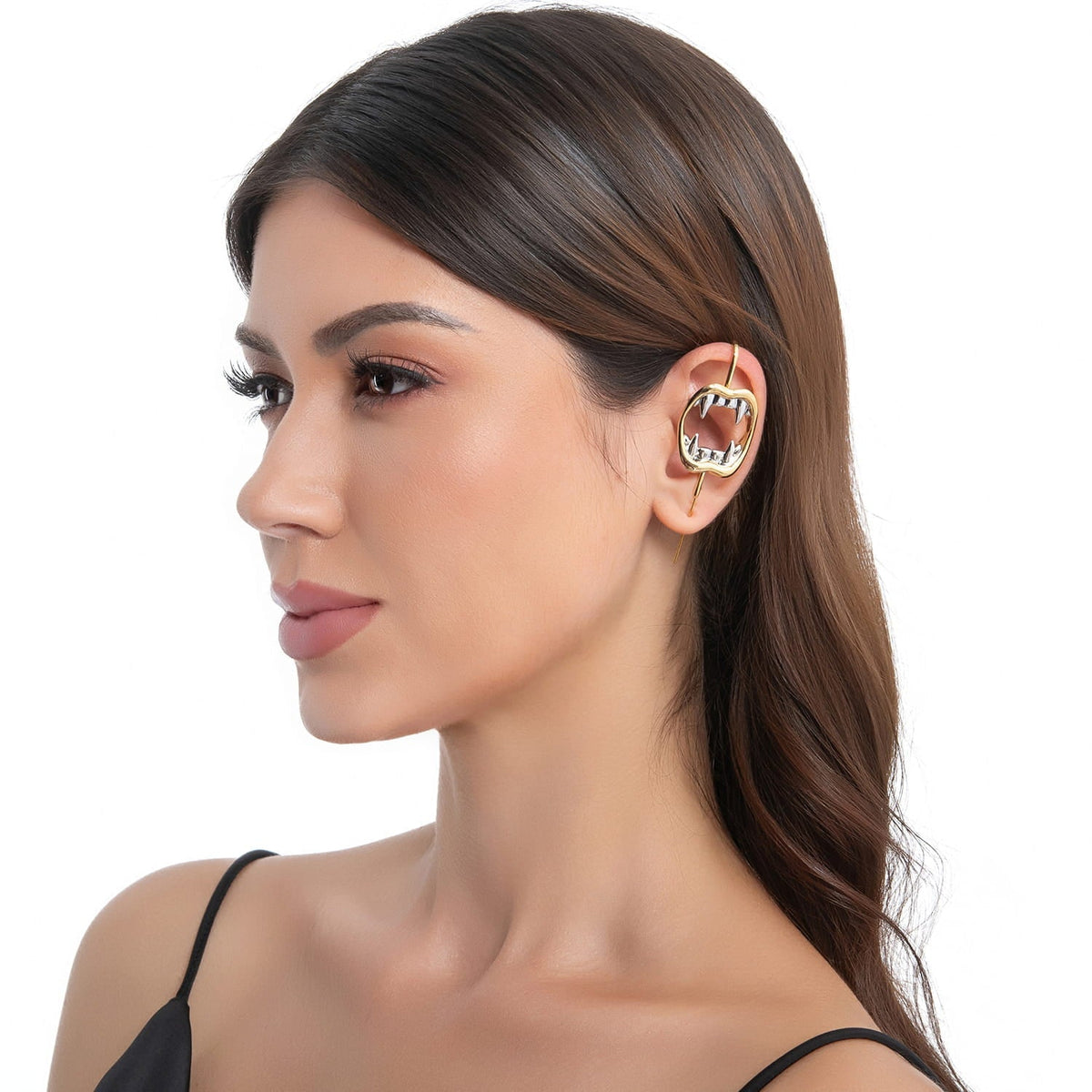 Vampire Fangs ear cuff in gold on a black ear form