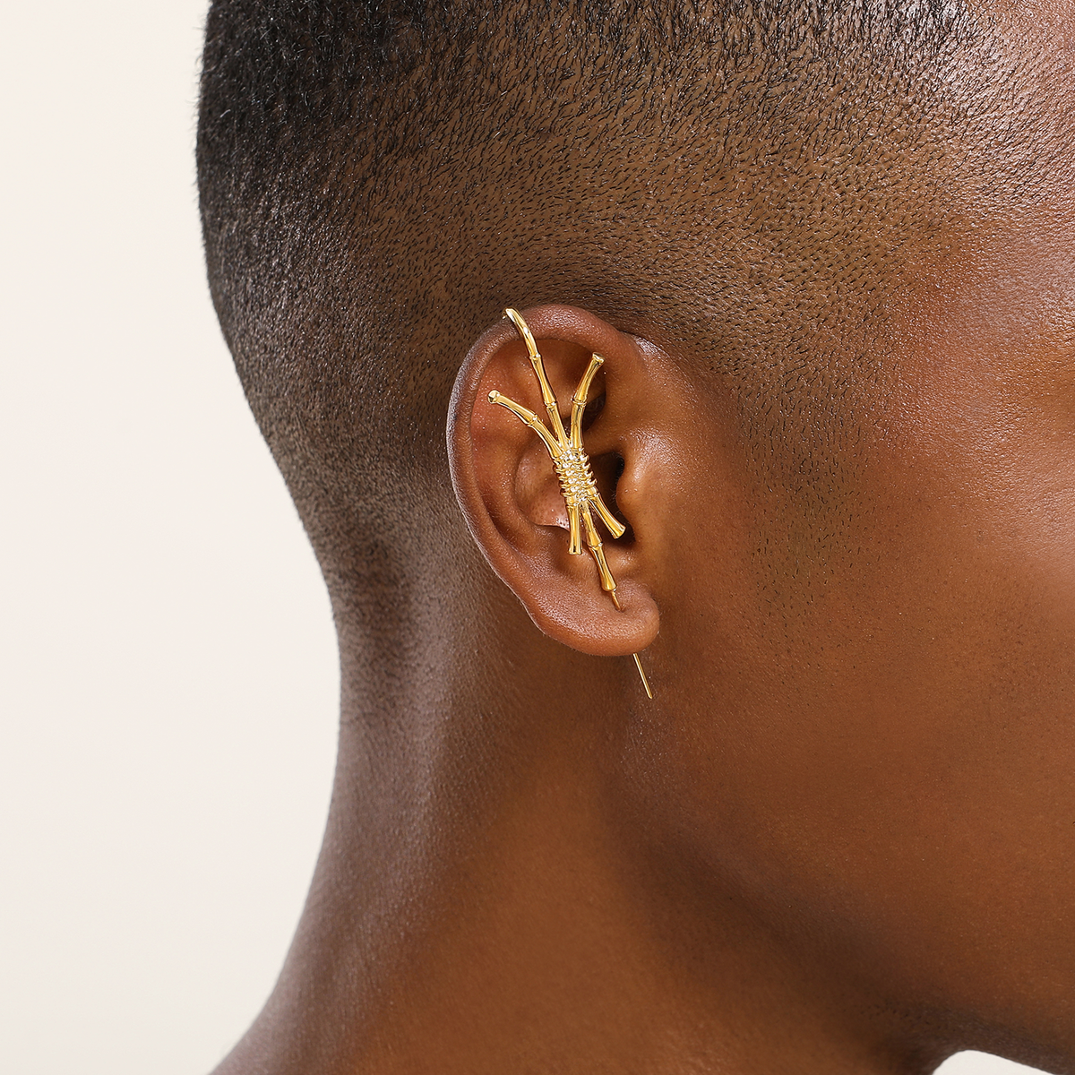 Ward of Protection ear cuff in gold worn on the ear, profile view