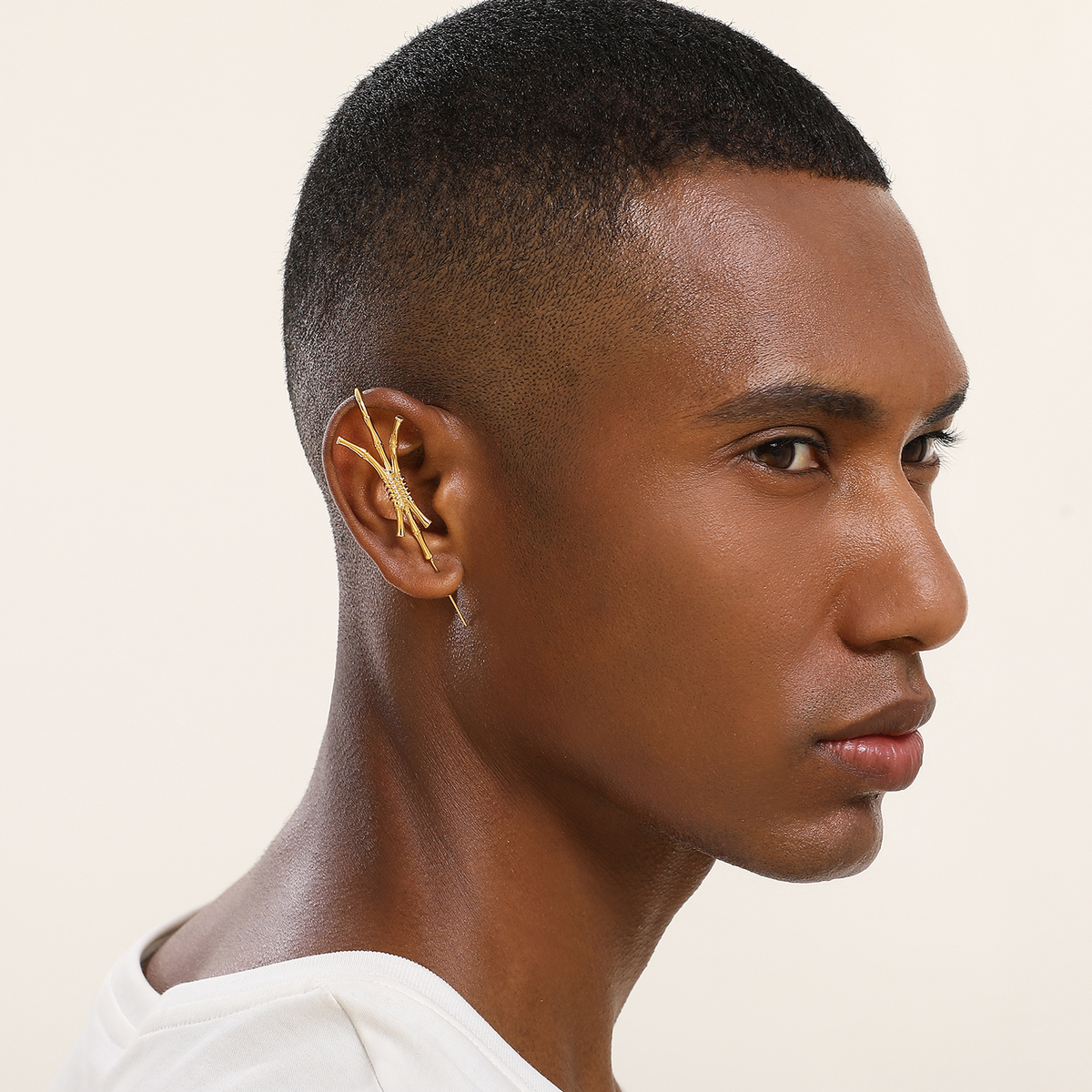Ward of Protection ear cuff in gold worn on the ear, profile view