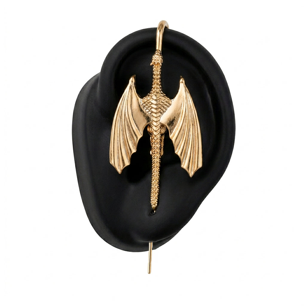 Stormscale ear cuff in gold on a black ear form