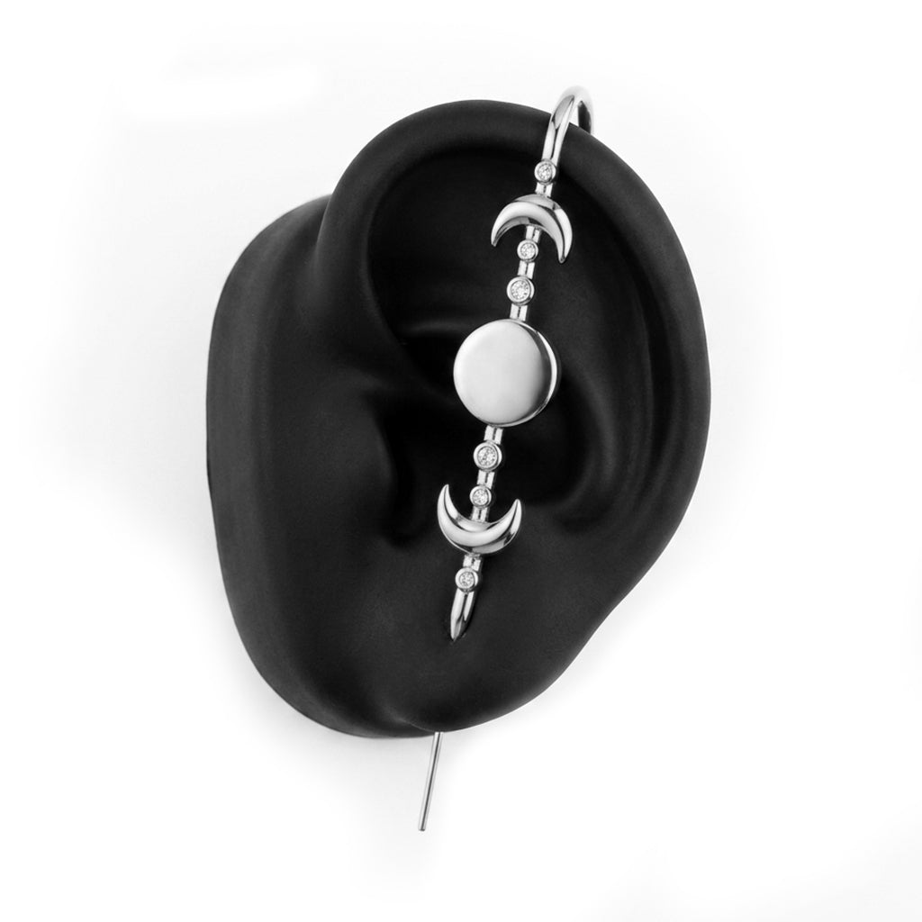 Moon Phases ear cuff in silver on a black ear form