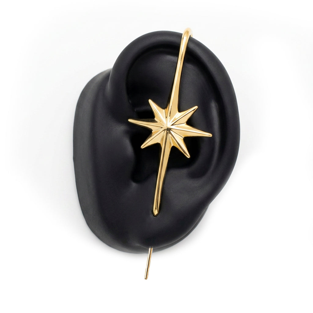 North Star ear cuff in gold on a black ear form