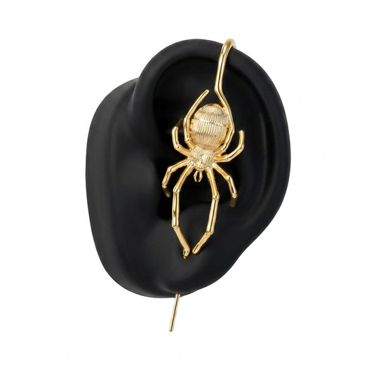 Arachnid Kiss ear cuff in gold on a black ear form
