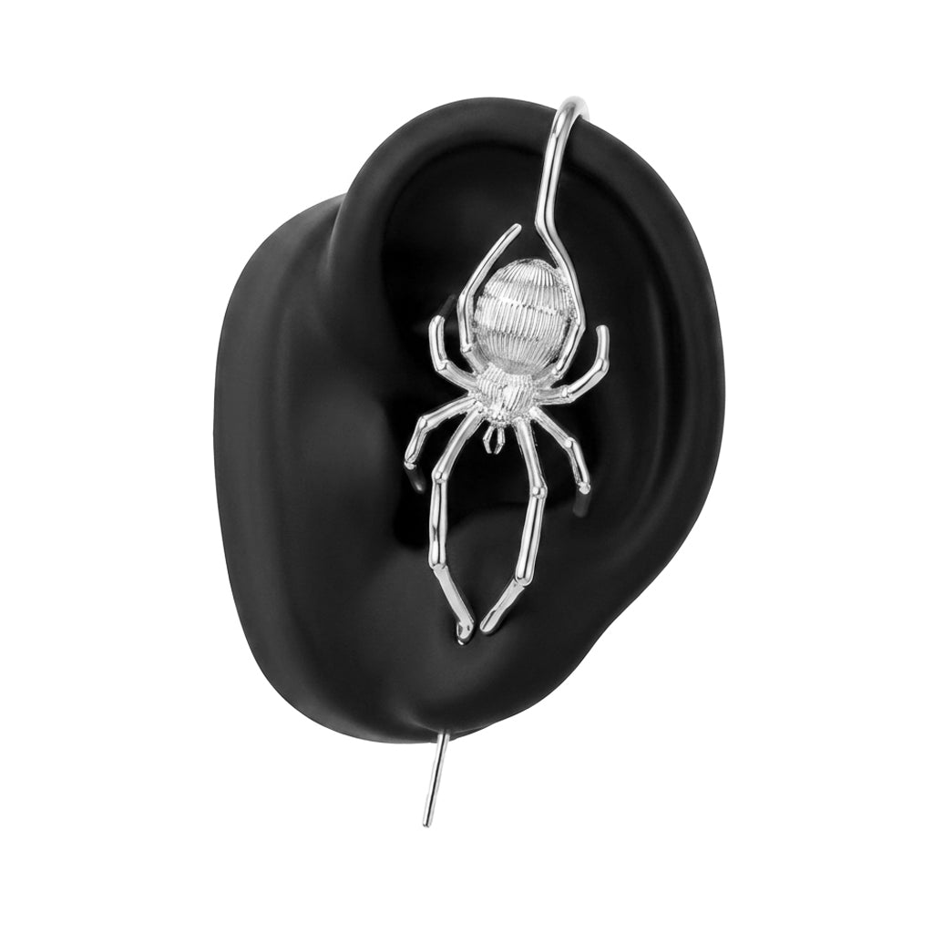 Arachnid Kiss ear cuff in silver on a black ear form