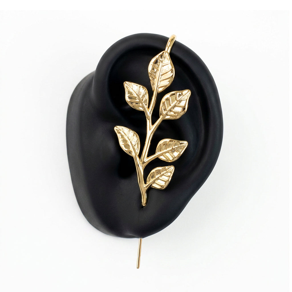 Whispering Leaves ear cuff in gold on a black ear form