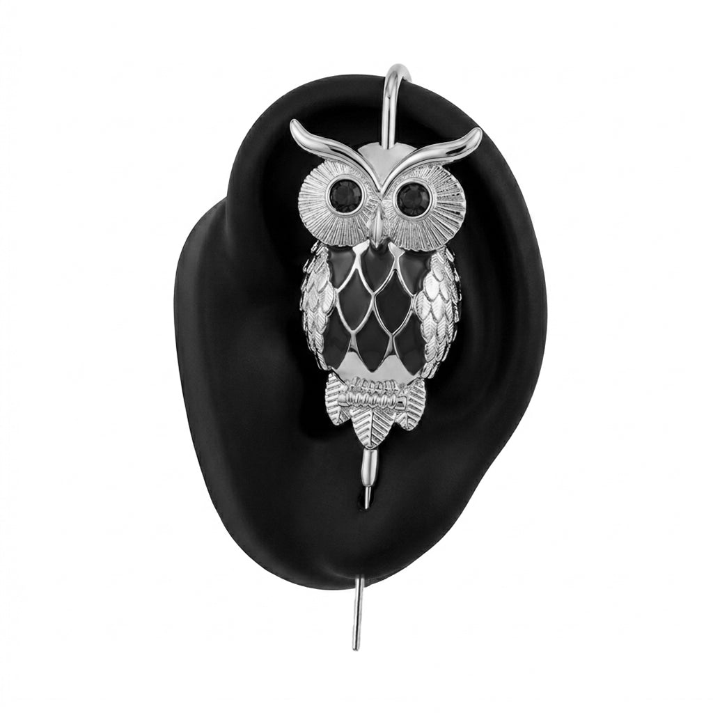 Night Owl ear cuff in silver on a black ear form