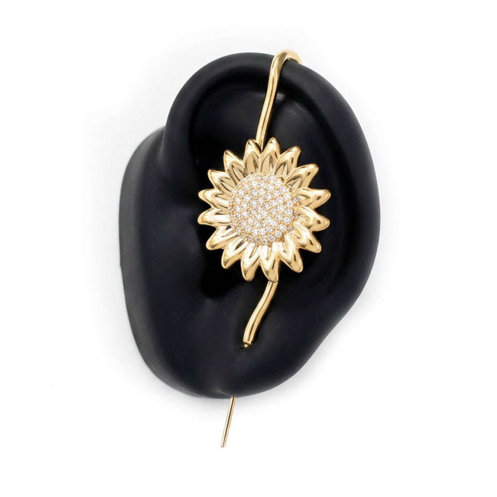 Sunflower ear cuff in gold on a black ear form