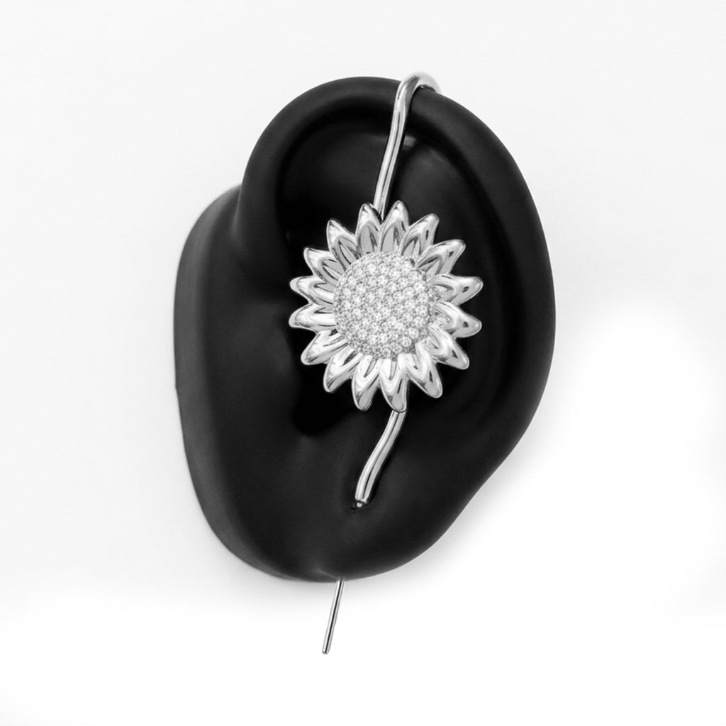 Sunflower ear cuff in silver on a black ear form