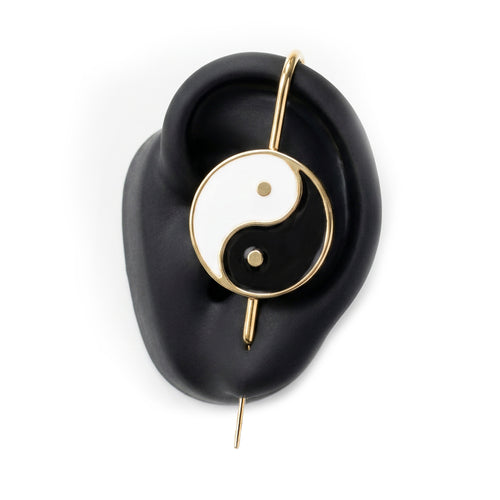 Yin & Yang ear cuff in gold on a black ear form