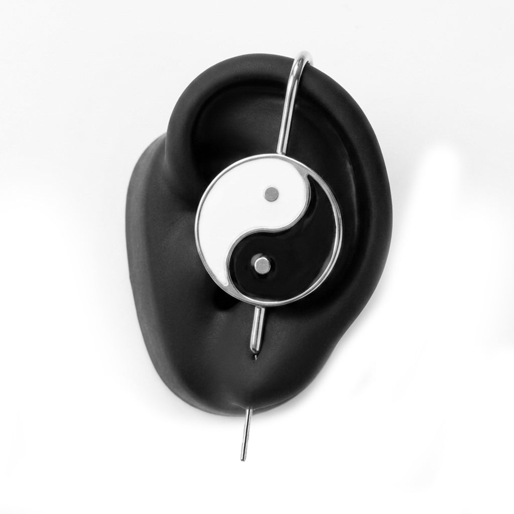 Yin & Yang ear cuff in silver on a black ear form