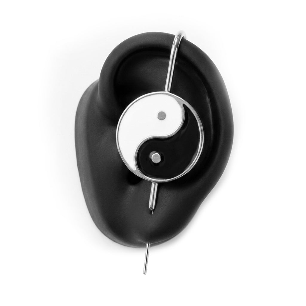 Yin & Yang ear cuff in silver on a black ear form