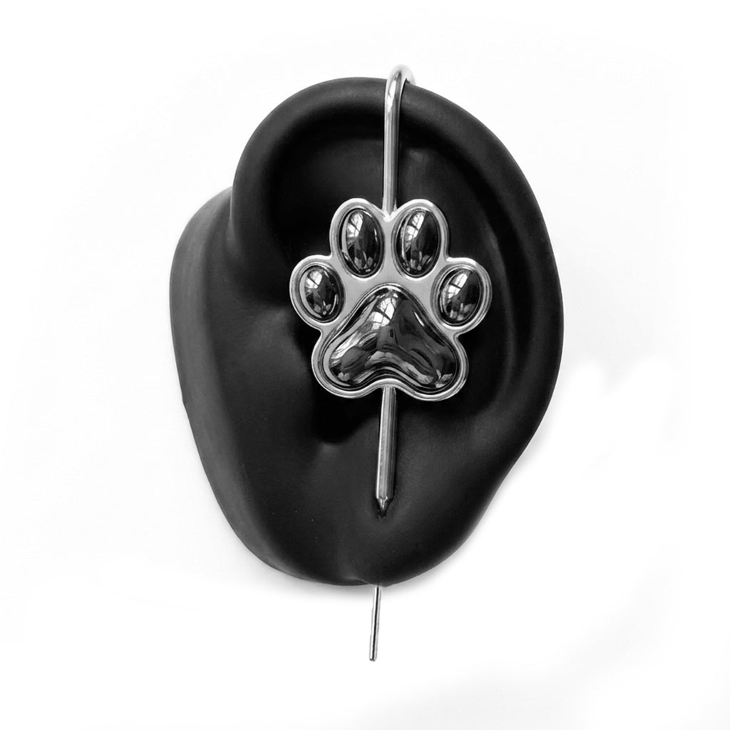Pawfect ear cuff in silver on a black ear form