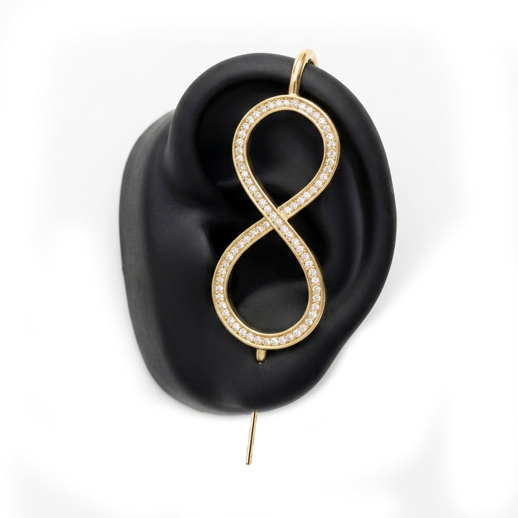 Infinity ear cuff in gold on a black ear form